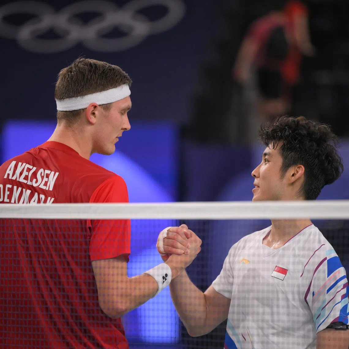 Singaporean shuttler Loh Kean Yew shakes hands with Denmark’s Viktor Axelsenafter the Paris 2024 Olympic Badminton Men’s quarter final on Aug 2.