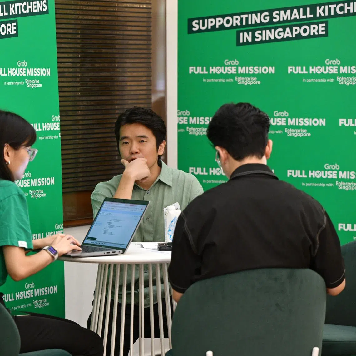 21 Moonstone Group’s managing director Jeremy Lim (centre) and his colleague (right) at the launch of Grab Full House Mission on June 9.