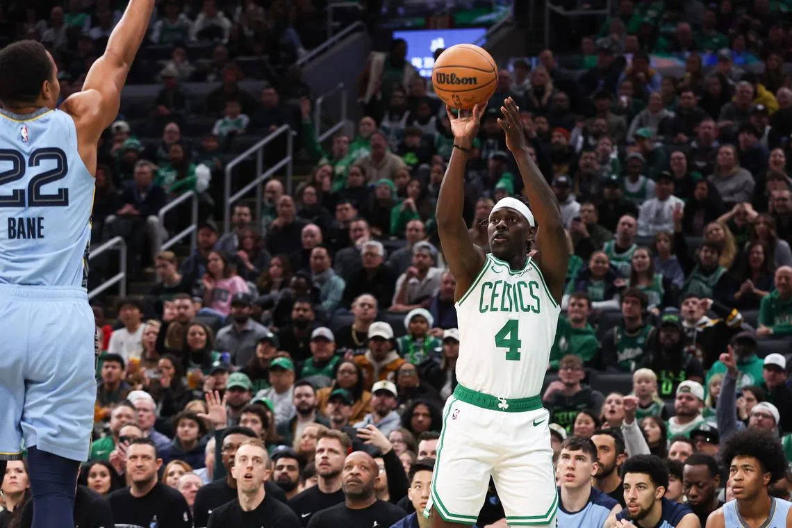Boston Celtics guard Jrue Holiday shoots during the first half against the Memphis Grizzlies at TD Garden.