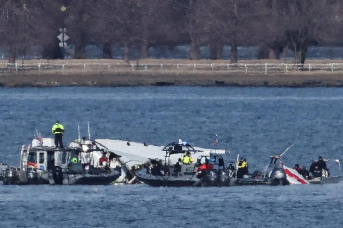 Emergency workers recovering debris from the Potomac River in the aftermath of the collision between American Eagle flight 5342 and a Black Hawk helicopter, on Jan 30.