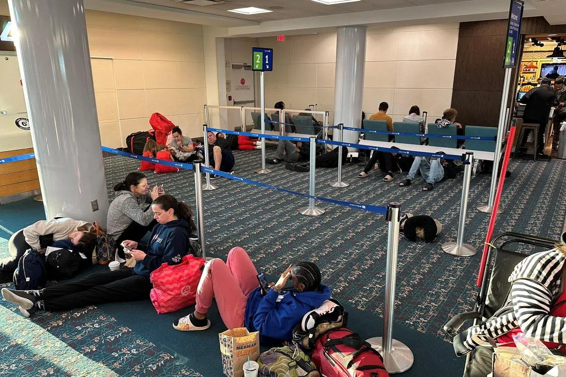 Stranded passengers wait at the Orlando International Airport, as flights were grounded after a system outage on Jan 11, 2023.