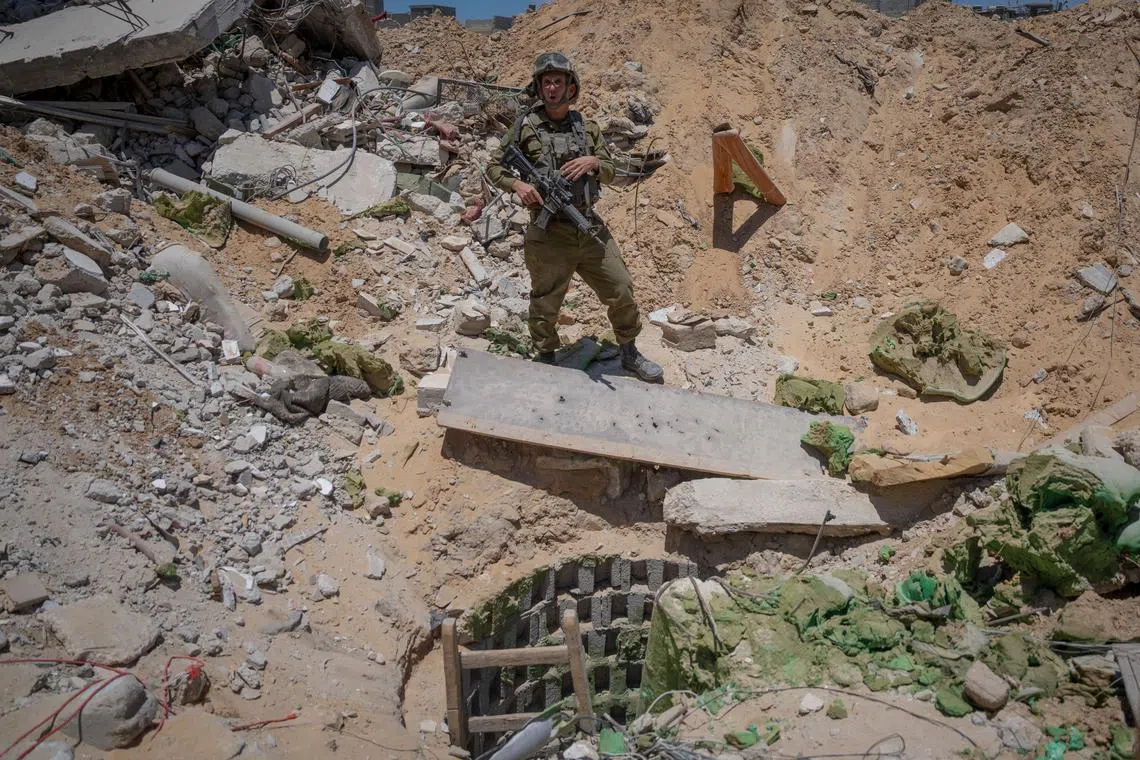 FILE PHOTO: Israeli military spokesperson, Rear Admiral Daniel Hagari, speaks to the media next to the entrance of a tunnel that the military says Hamas militants used in the southern Gaza Strip, amid the Israel-Hamas conflict, July 3, 2024. Ohad Zwigenberg/Pool via REUTERS/File Photo