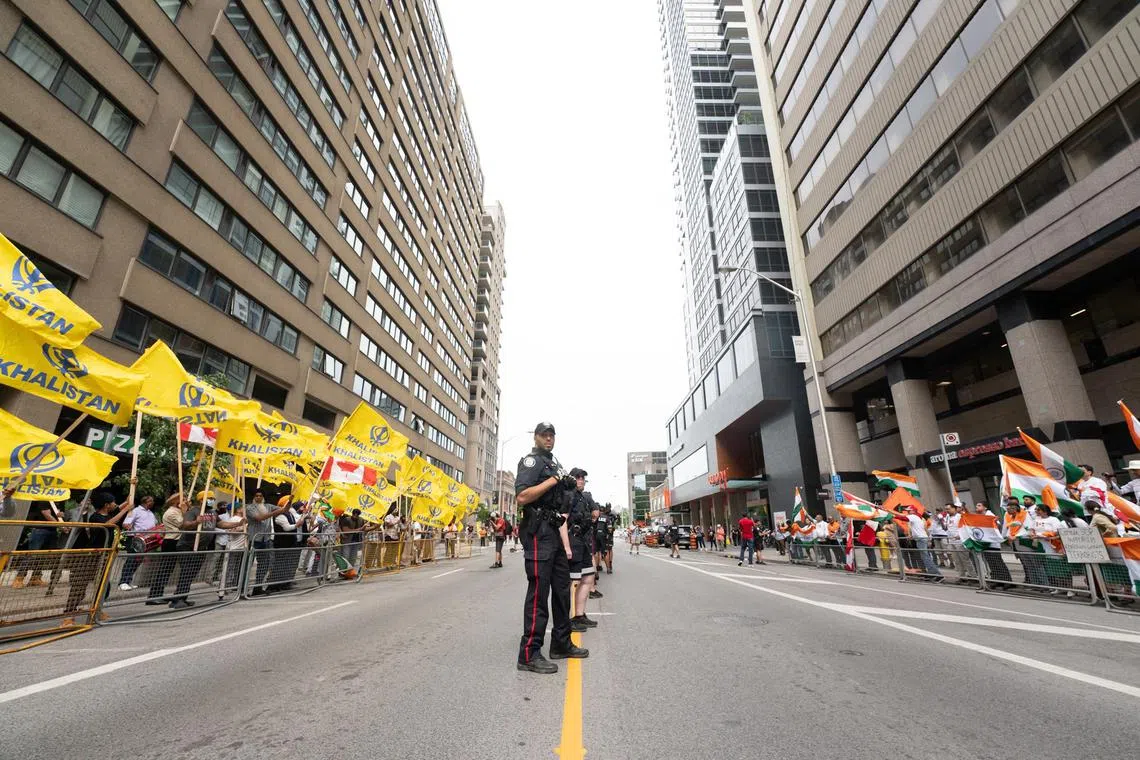 Sikhs protesting for an independent Khalistan (left) and pro-India supporters in front of the Indian consulate in Toronto on July 8.