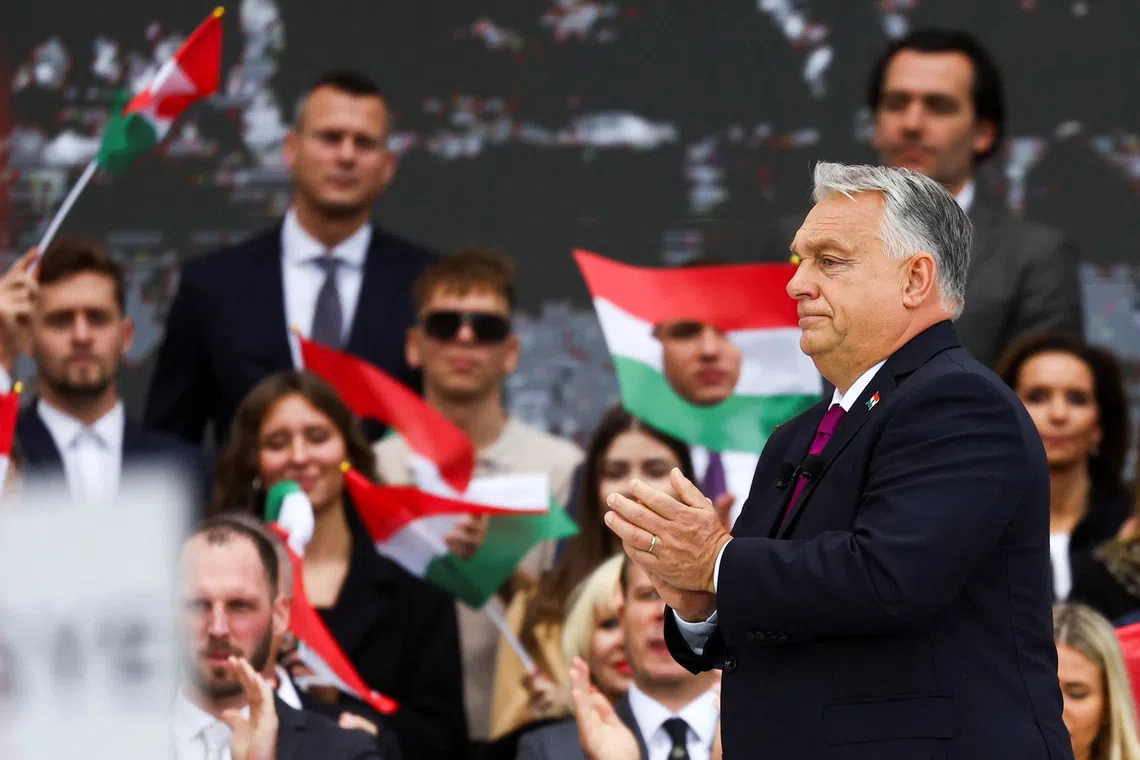 Hungarian Prime Minister Viktor Orban applauds after delivering a speech to mark the 69th anniversary of the Hungarian Uprising of 1956, in Budapest, Hungary, October 23, 2025. REUTERS/Bernadett Szabo