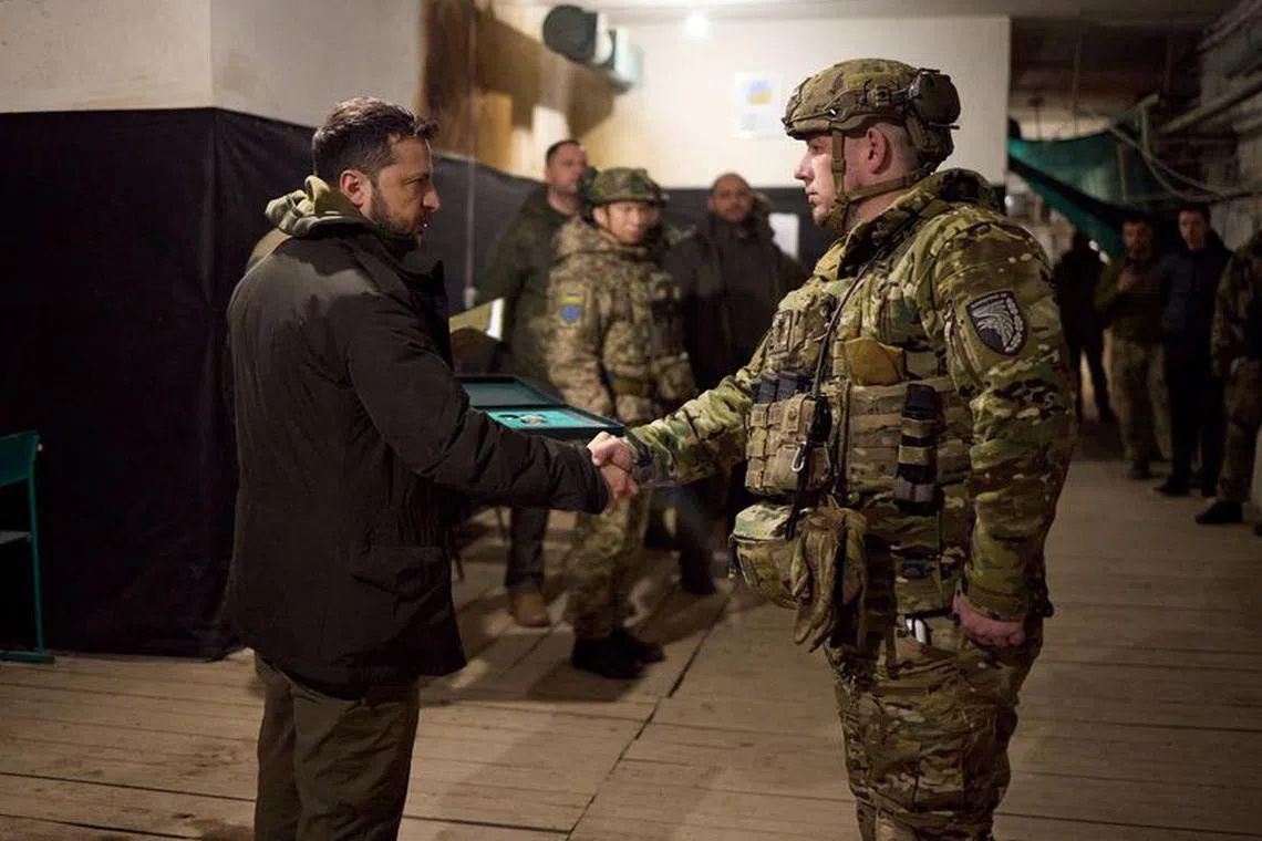 FILE PHOTO: Ukraine's President Volodymyr Zelenskiy awards a Ukrainian serviceman at a position in the town of Kupiansk, amid Russia's attack on Ukraine, in Kharkiv region, Ukraine November 30, 2023. Ukrainian Presidential Press Service/Handout via REUTERS/File Photo