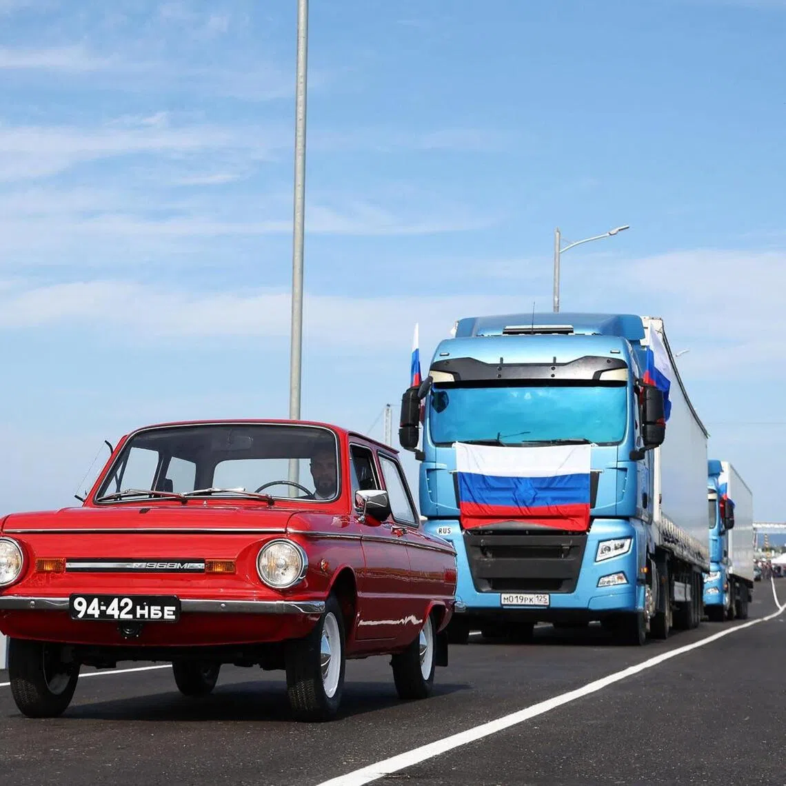 In this handout image released by the Russian Transport Ministry on September 7, 2026, Russian trucks and a Zaporozhets car cross the new Russia-North Korea road bridge over the Tumen River, during the opening ceremony. (Photo by Handout / Russian Transport Ministry / AFP) / RESTRICTED TO EDITORIAL USE - MANDATORY CREDIT "AFP PHOTO / Russian Transport Ministry" - HANDOUT - NO MARKETING NO ADVERTISING CAMPAIGNS - DISTRIBUTED AS A SERVICE TO CLIENTS