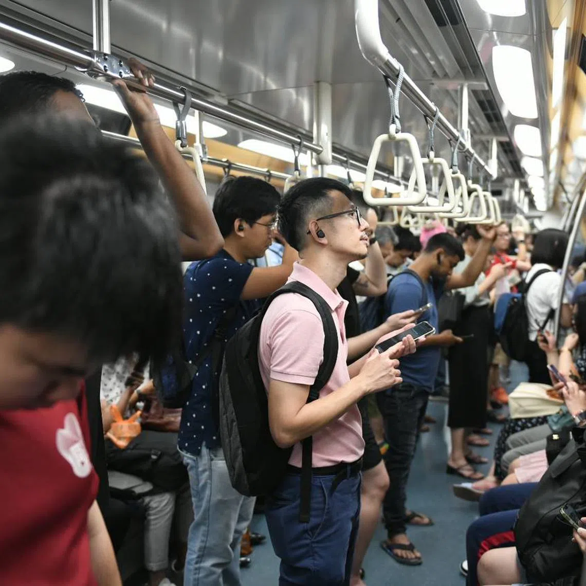 Commuters on a train stopping at Kovan MRT station at about 9.35pm on March 29, 2023.