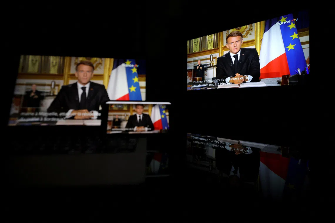 Image 2: French President Emmanuel Macron appears on screen as he makes a television address to the nation a day after clashes during a national day of demonstrations against the cost of living and rising fuel prices, near Marseille, France, on Oct 18.