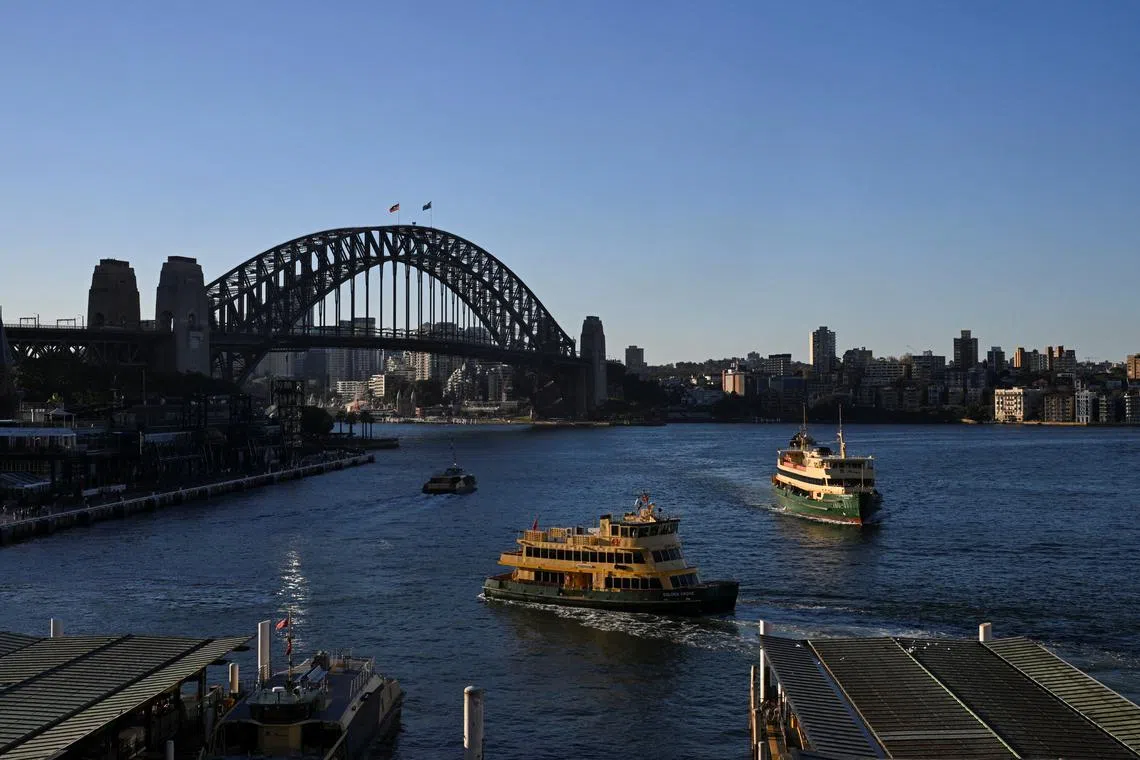 Passenger ferries move by the Sydney Harbour Bridge in Circular Quay, Sydney, Australia, May 14, 2024. REUTERS/Jaimi Joy/ File Photo