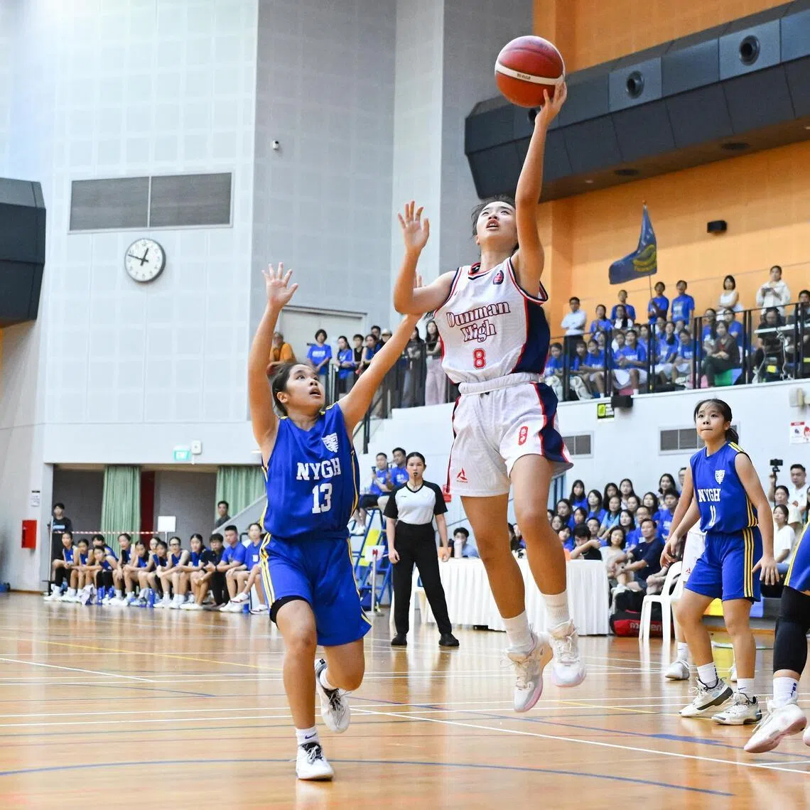 Nanyang Girls' High School's Jovia Teo (centre, left) blocking Dunman High School's Oh Yu Tong during the National School Games B Division girls' basketball final on April 28.