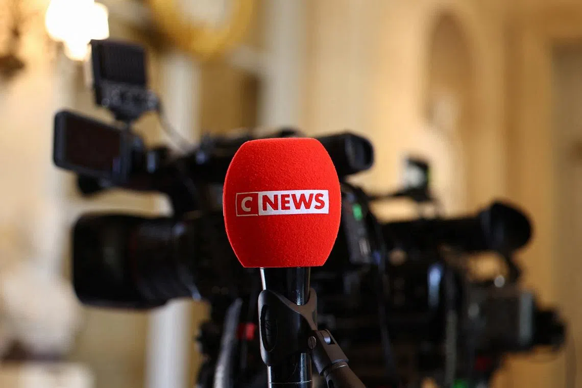 The logo of CNEWS, a French private national 24-hour news television channel, is seen on a microphone as journalists work at the National Assembly in Paris, France, April 27, 2026. REUTERS/Abdul Saboor