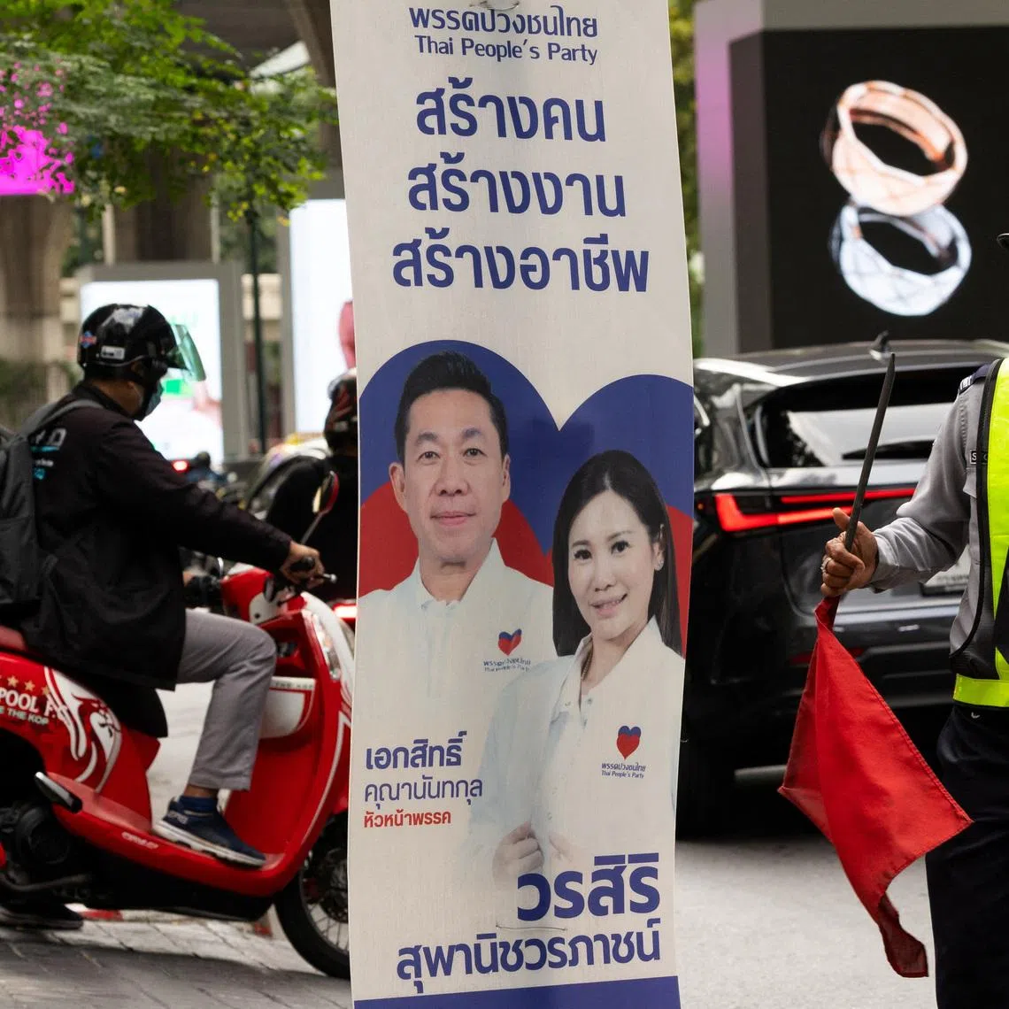 A security officer looks on next to the People's Party electoral campaign posters, before Thailand general elections on February 8, in Bangkok, Thailand, February 4, 2026. REUTERS/Maxim Shemetov