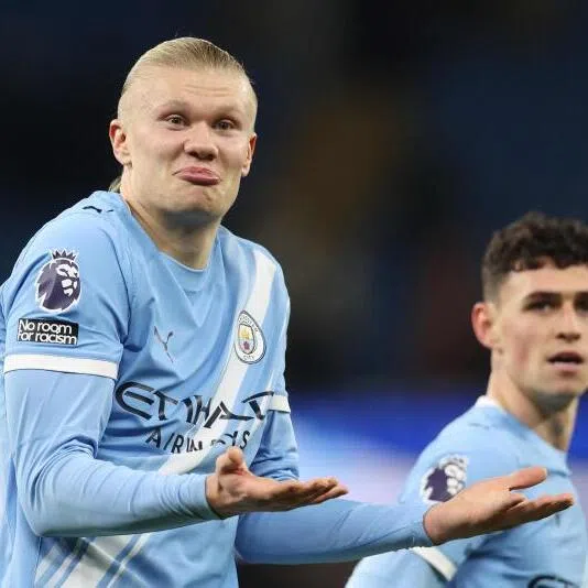 Manchester City's striker Erling Haaland (left) gestures to the West Ham fans at the end of the match.