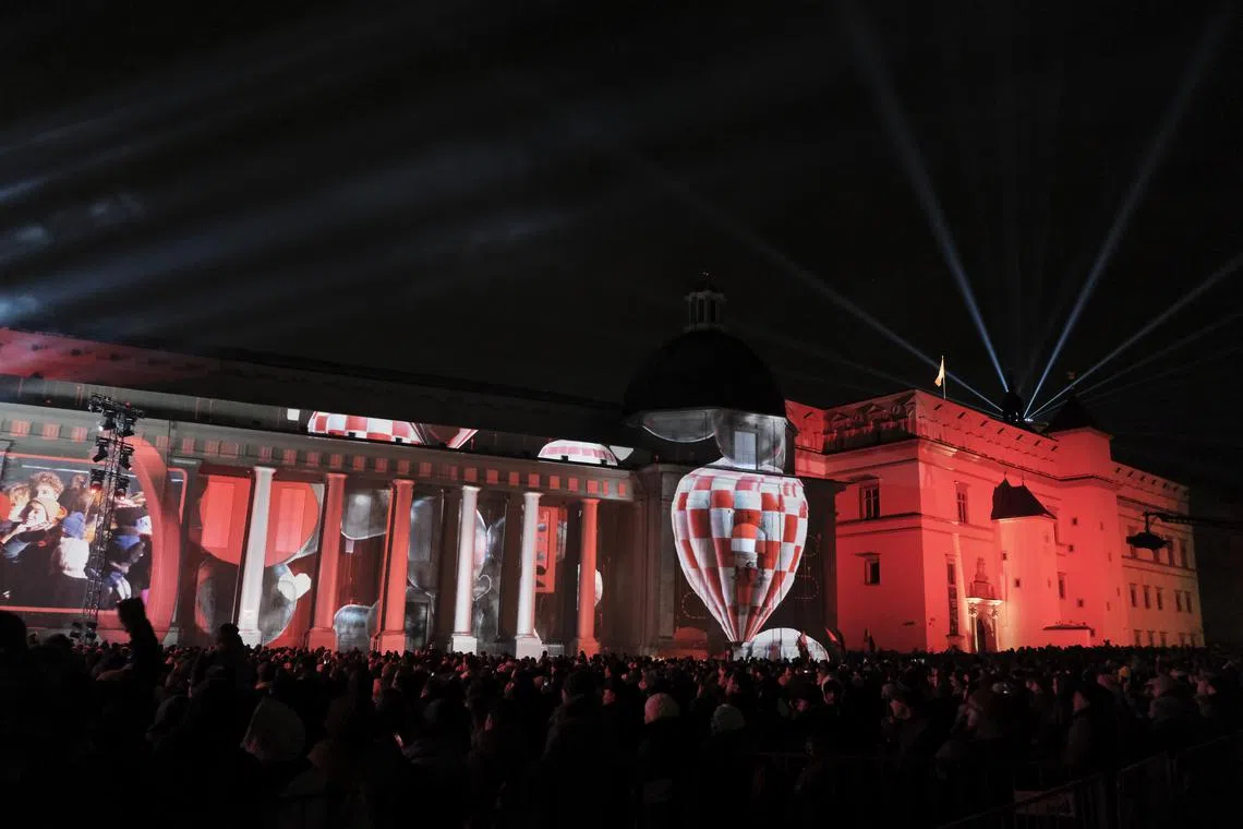 People watch a musical and visual journey titled 'Time Portal' during the Vilnius 700th anniversary celebration, in Vilnius, Lithuania, Jan 25, 2023. 