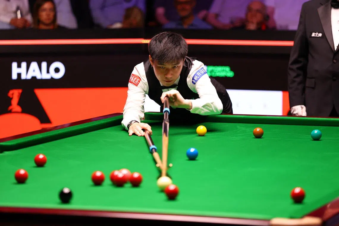 China's Zhao Xintong in action during his semi-final match against England's Ronnie O'Sullivan.