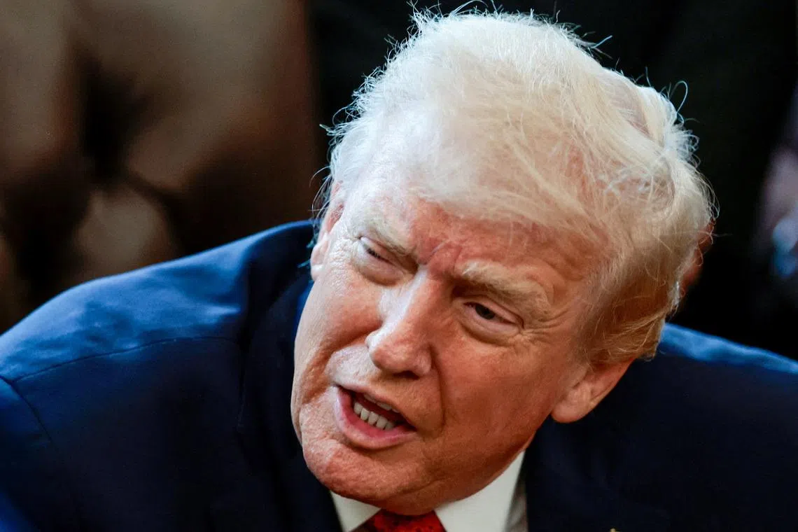 FILE PHOTO: U.S. President Donald Trump speaks in the Oval Office as he signs an executive order, at the White House in Washington, D.C., U.S., December 18, 2025. REUTERS/Evelyn Hockstein/File Photo