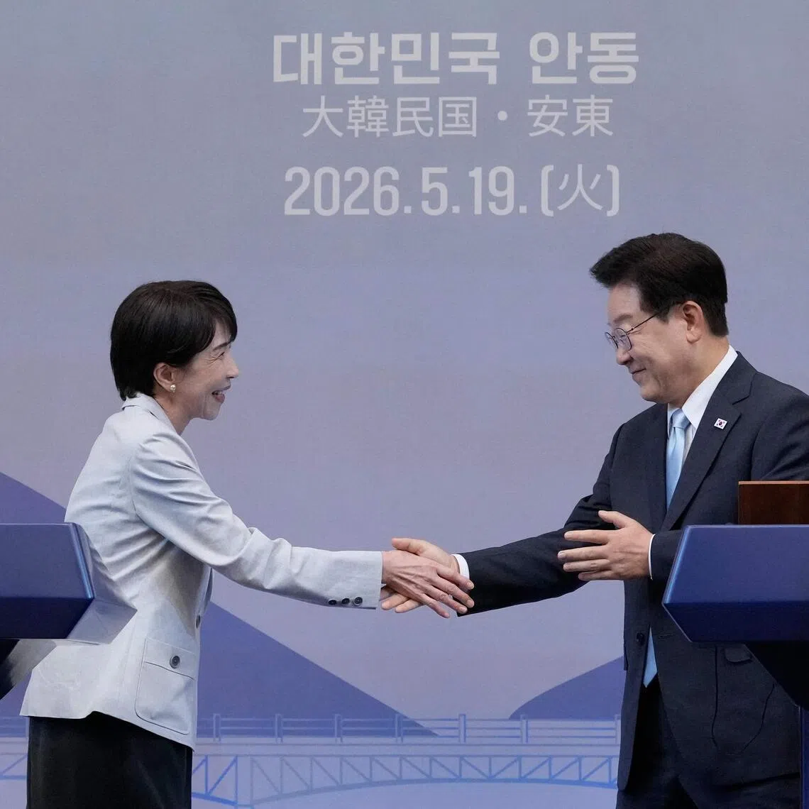 Japanese Prime Minister Sanae Takaichi shaking hands with South Korean President Lee Jae Myung at a meeting in Andong on May 19.