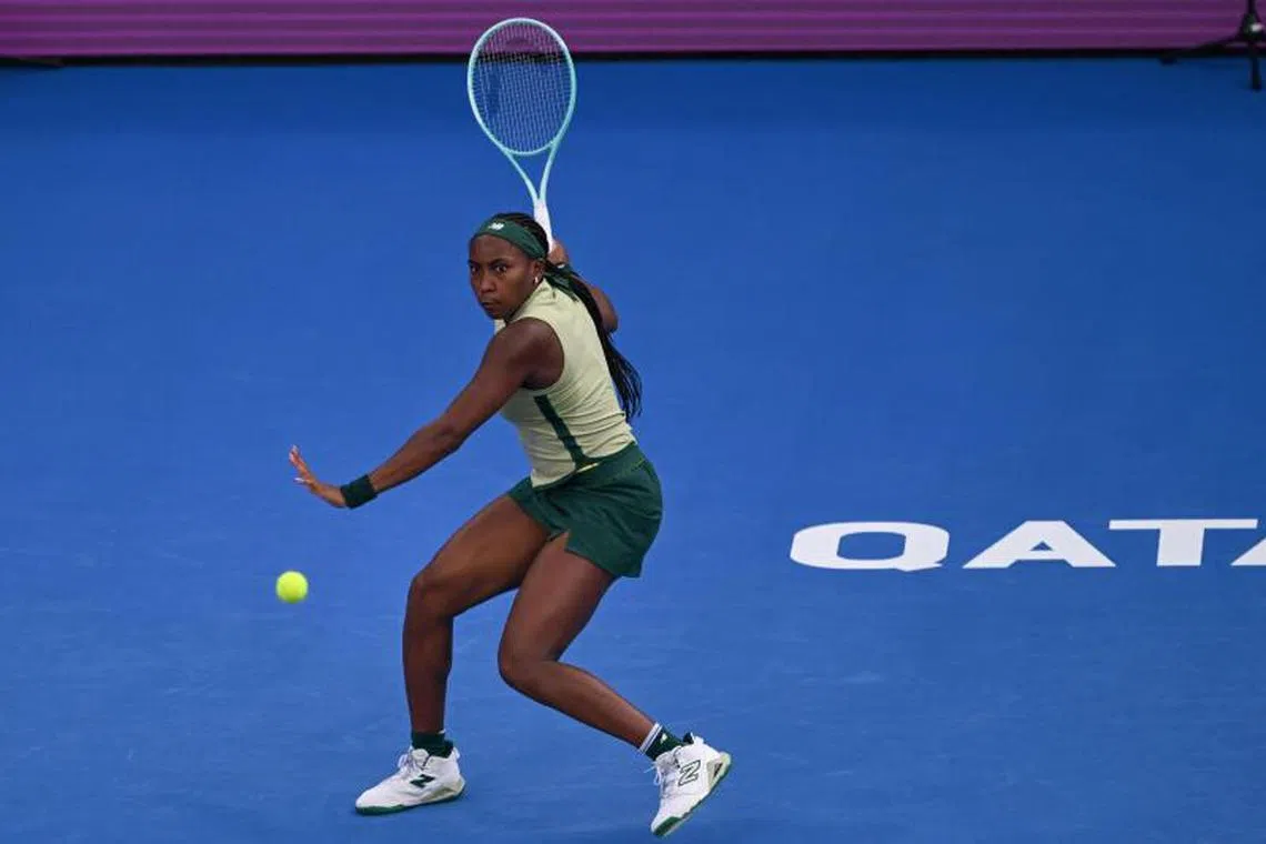 Coco Gauff of the USA returns the ball to Marta Kostyuk of the Ukraine during their 2025 WTA Qatar Open match at the Khalifa International Tennis Complex in Doha on February 11, 2025. (Photo by Mahmud HAMS / AFP)