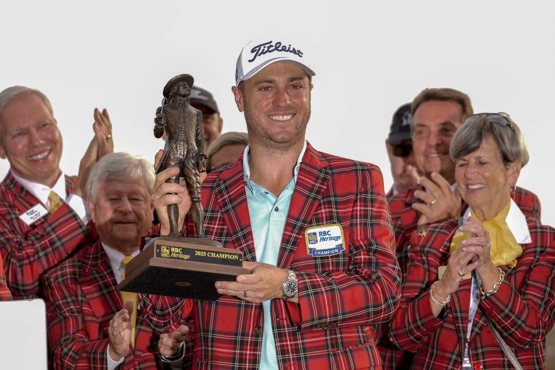 Apr 20, 2025; Hilton Head, South Carolina, USA; Justin Thomas holds his trophy and wears the plaid jacket after winning the final round of the RBC Heritage golf tournament. Mandatory Credit: Jim Dedmon-Imagn Images