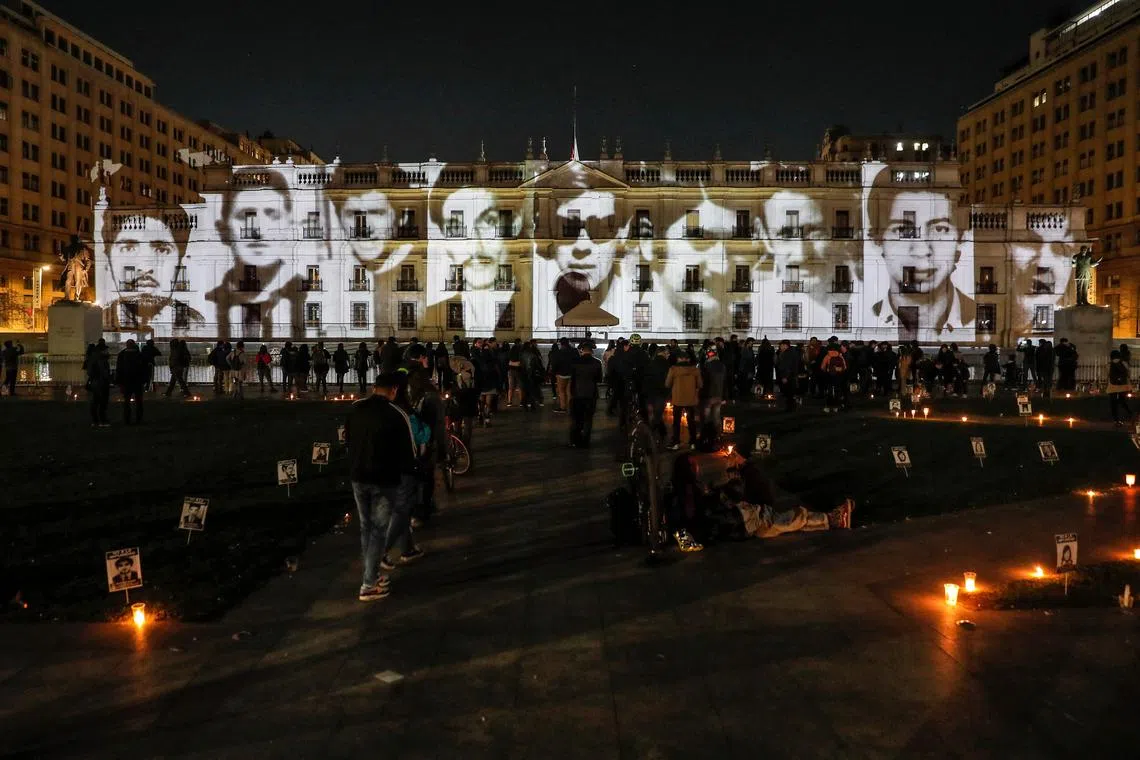Images of disappeared detainees are projected on the facade of the Palacio de la Moneda in Santiago on Aug 30.