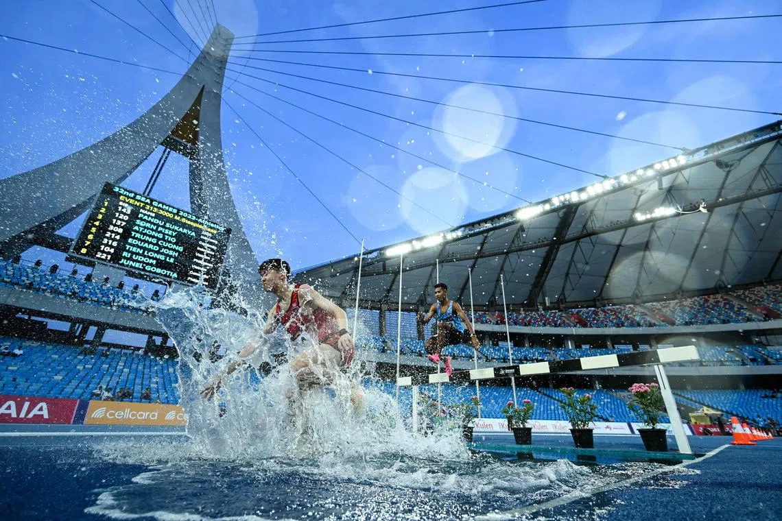 Athletes competing in the men's 3000m steeplechase final during the 32nd Southeast Asian Games (SEA Games) in Phnom Penh on May 10.