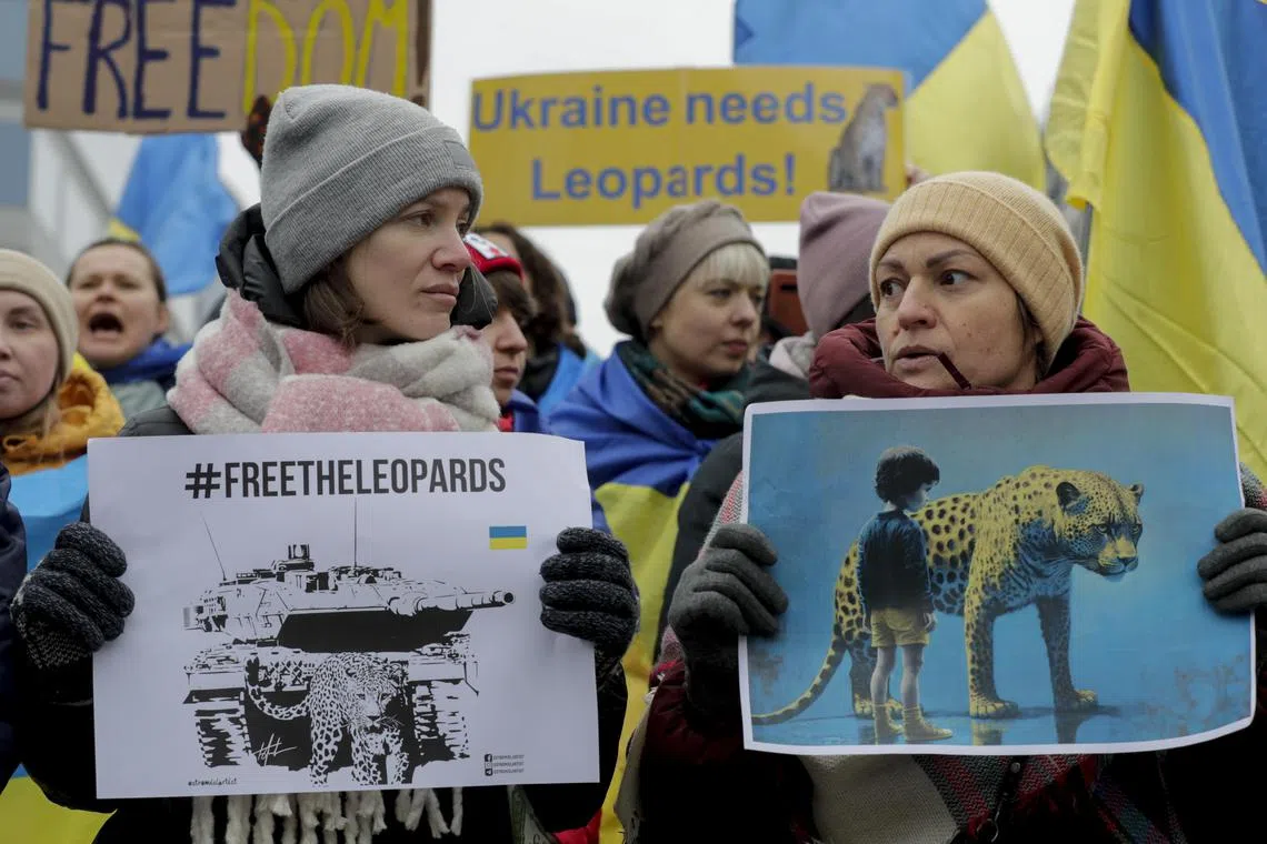 Ukrainians hold placards and wave Ukrainian flags during a rally in Brussels supporting the deployment of Leopard tanks and other military equipment to Ukraine, on Jan 23, 2023.