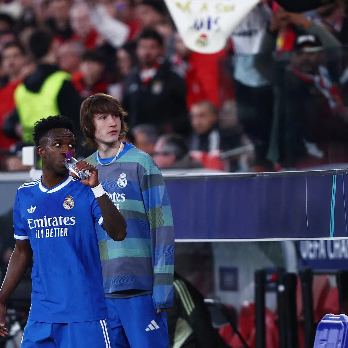 Soccer Football - UEFA Champions League - Play Off - First Leg - Benfica v Real Madrid - Estadio da Luz, Lisbon, Portugal - February 17, 2026 Real Madrid's Vinicius Junior looks on from the side of the pitch as the match was stopped due to racist chants REUTERS/Rodrigo Antunes
