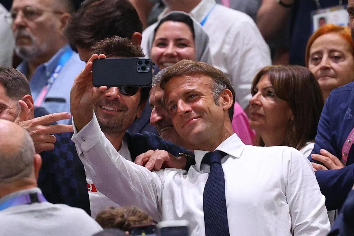 French President Emmanuel Macron takes a selfie with Jimmy Fallon during the Olympic men's basketball final between the hosts and the United States on Aug 10. 