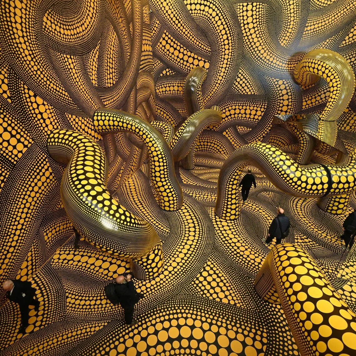 Visitors walking through a Yayoi Kusama art installation Infinity Mirrored Room at the Museum Ludwig in Cologne, Germany.