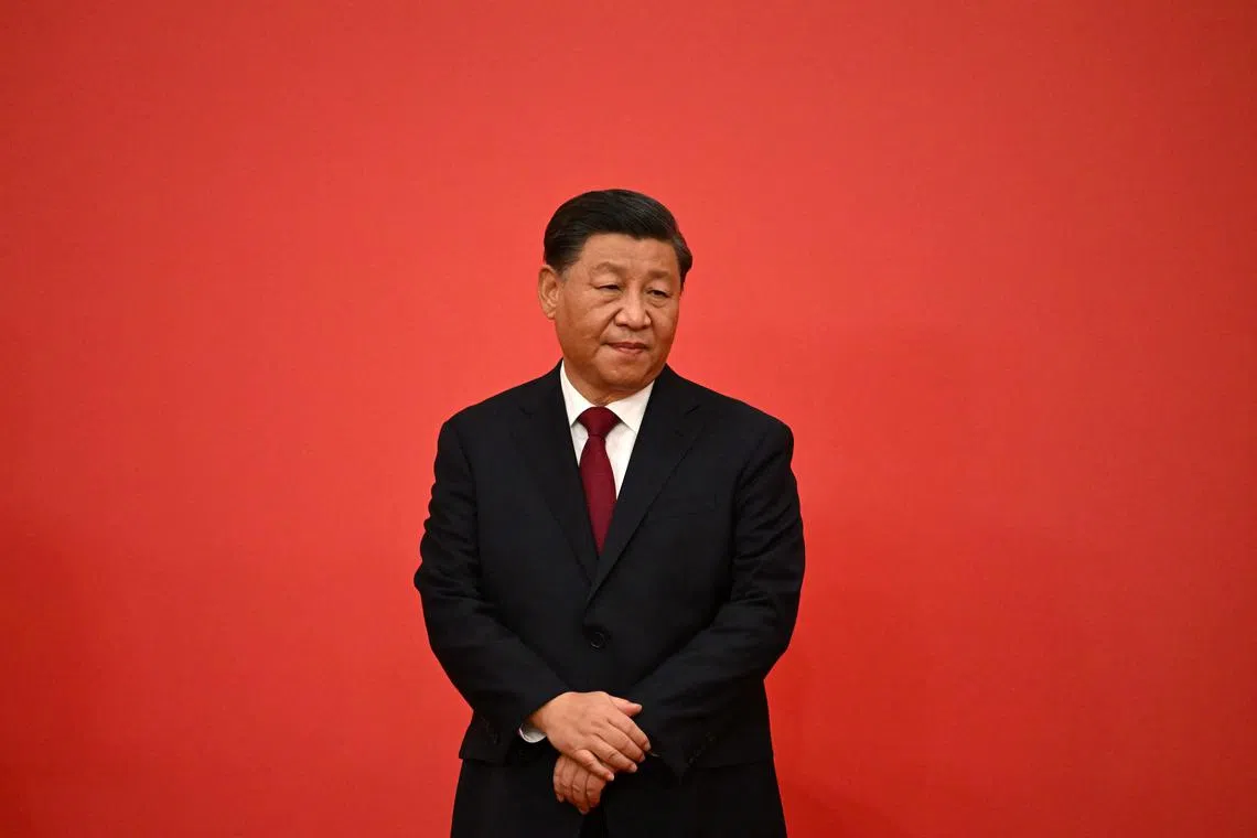 China's President Xi Jinping stands with other new members of the Communist Party of China's Politburo Standing Committee as they meet the media in the Great Hall of the People in Beijing on October 23, 2022. (Photo by Noel CELIS / AFP)