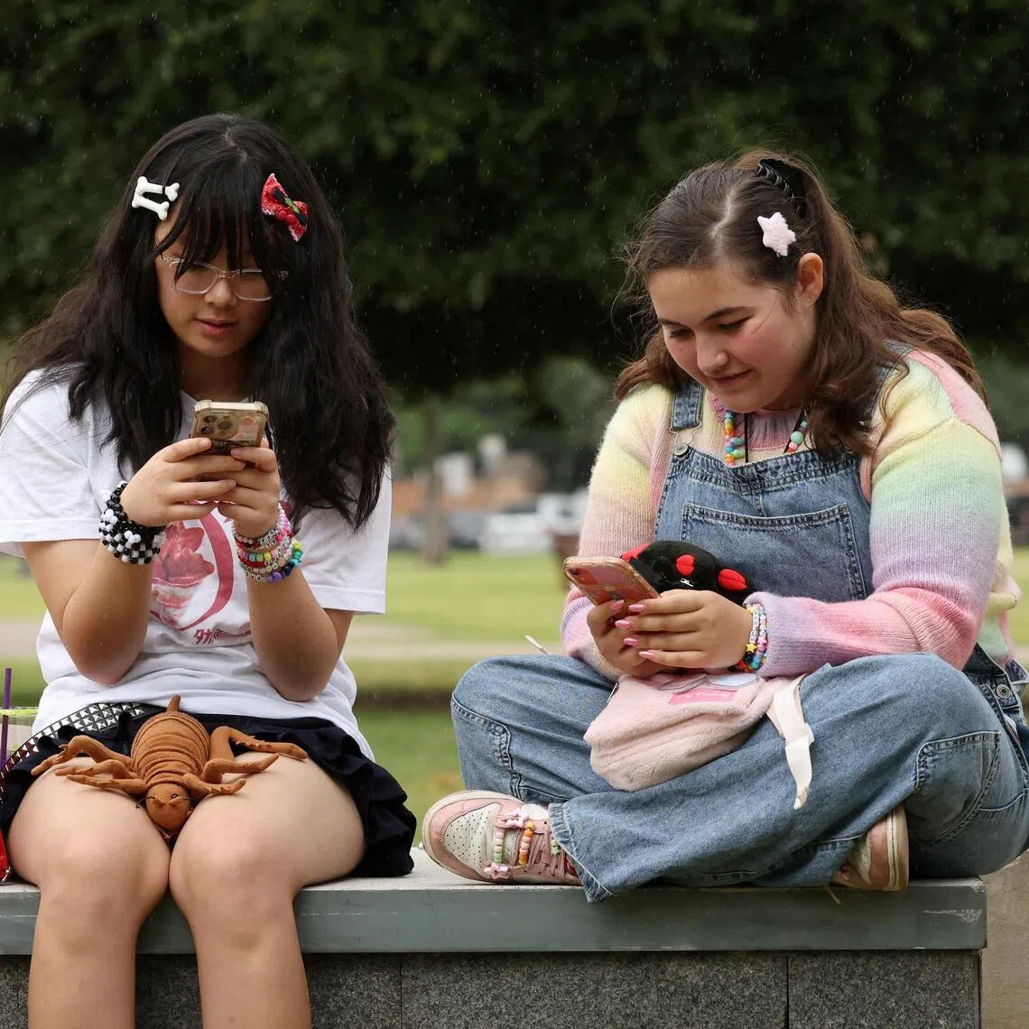 Teens on their phones in Sydney. A new Australian law bars children under 16 from having social media accounts.