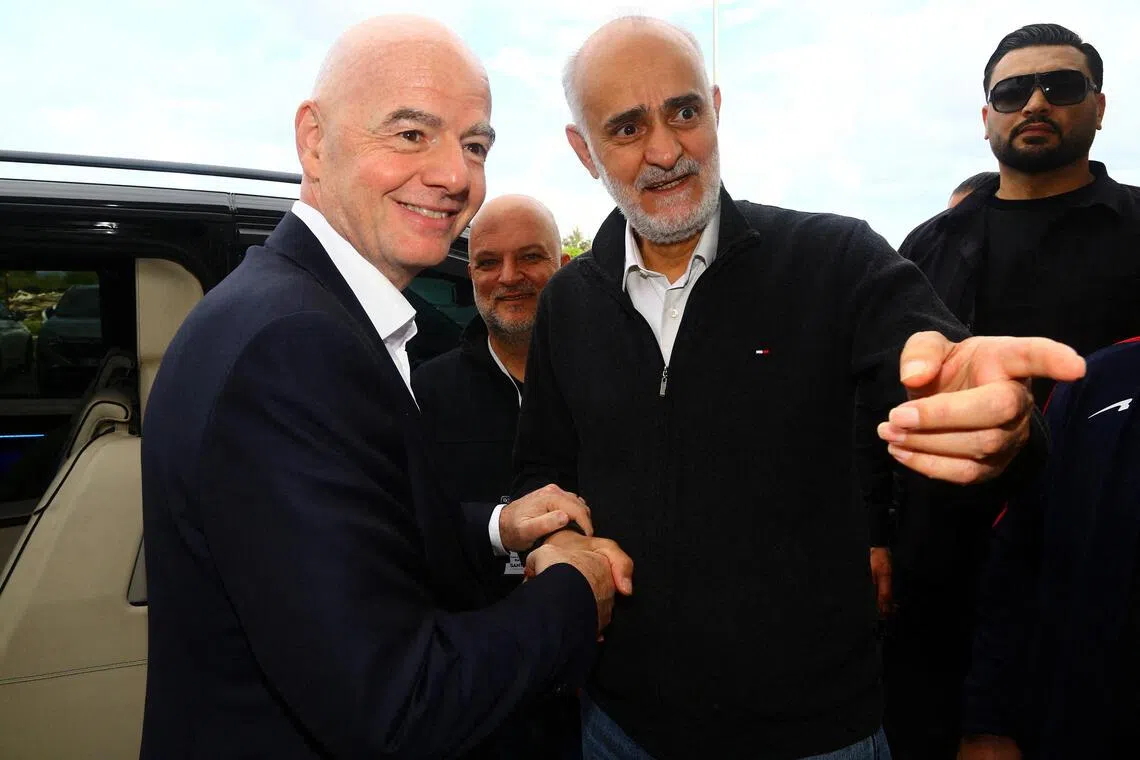 The first vice-president of the Iran football federation Mehdi Mohammad Nabi (right) greeting Fifa president Gianni Infantino before Iran's friendly with Costa Rica in Antalya, Turkey, on March 31, 2026.