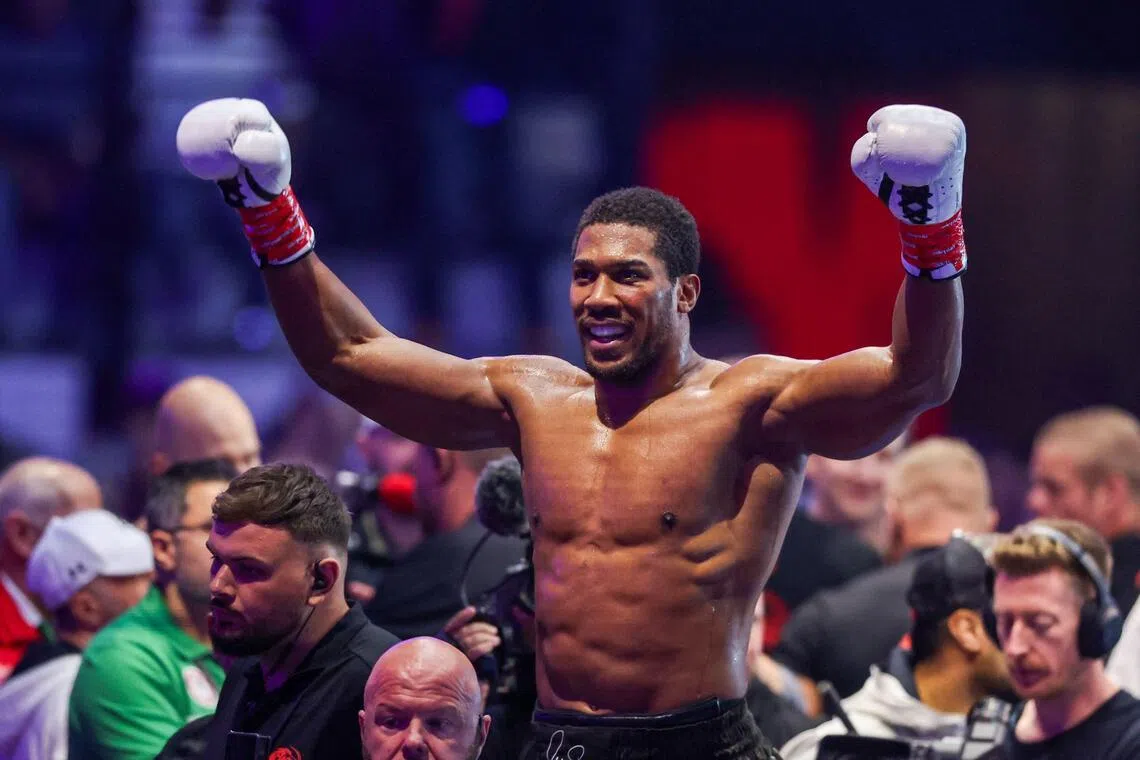 Two-time heavyweight world champion Anthony Joshua (above) survived two early knockdowns on the way to a second-round knockout of Kristian Prenga on July 26.