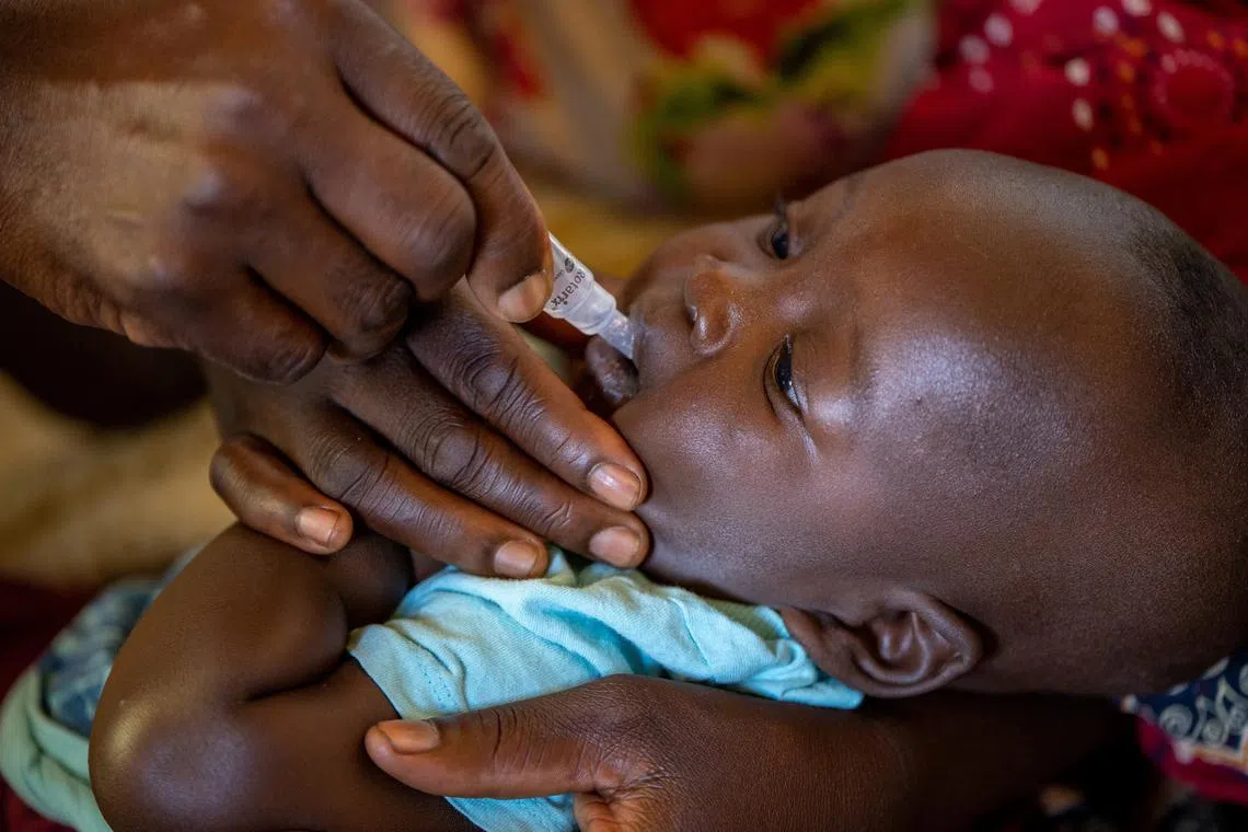 FILE PHOTO: A child receives an oral Malaria vaccine at Chileka Health Center, in Lilongwe, Malawi in this undated handout photo. Benny Khanyizira/UNICEF/Handout via REUTERS/File Photo