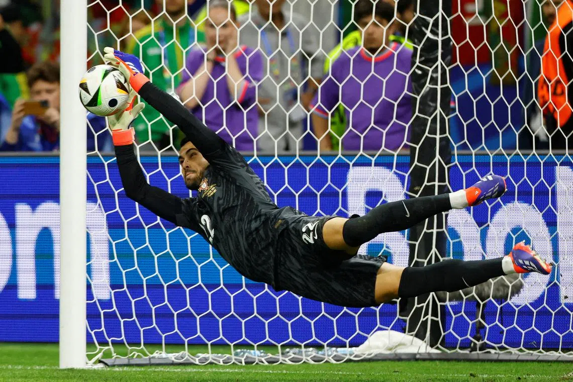 FILE PHOTO: Soccer Football - Euro 2024 - Round of 16 - Portugal v Slovenia - Frankfurt Arena, Frankfurt, Germany - July 1, 2024  Portugal's Diogo Costa saves a penalty during the shootout missed by Slovenia's Jure Balkovec REUTERS/Wolfgang Rattay/File Photo
