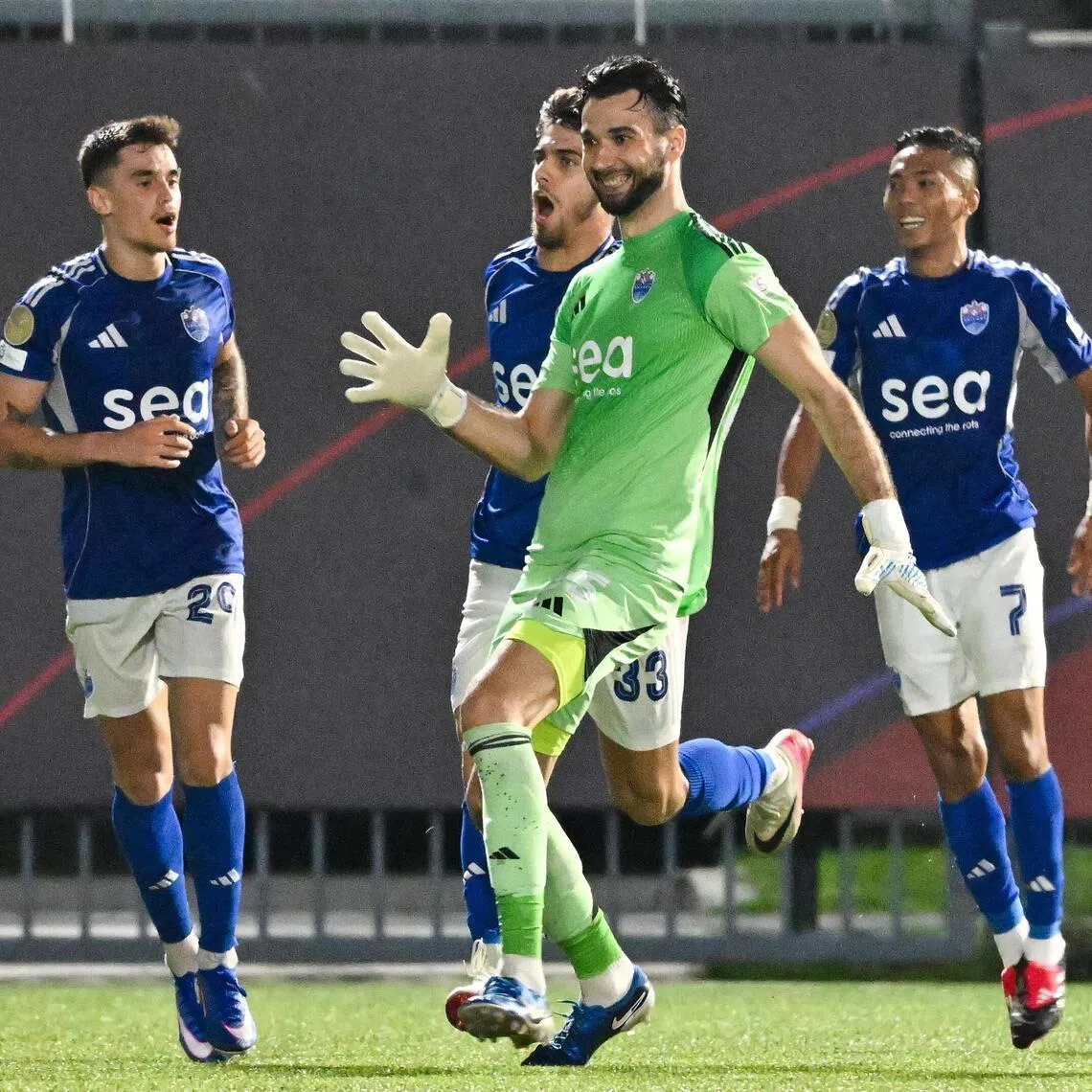 ST20260228-202678200828-Lim Yaohui-kksoc28/
Lion City Sailors goalkeeper Ivan Susak (in green) celebrating after helping to score a goal during the Singapore Premier League match between Lion City Sailors (in blue) and Albirex Niigata (in orange) during second half at Jurong East Stadium on Feb 28, 2026. It ended in a draw.
(ST PHOTO: LIM YAOHUI)