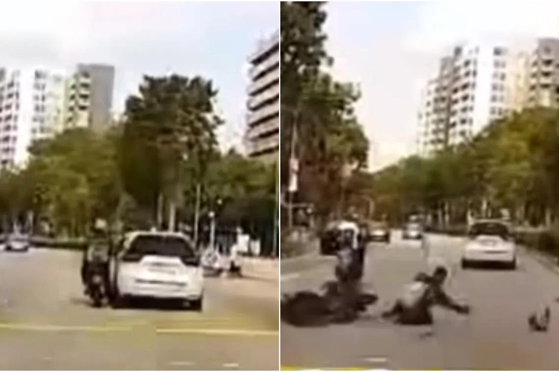 In a video posted on Facebook, the white car hits the motorcycle as it passes, causing the motorcyclist to fall off the bike.