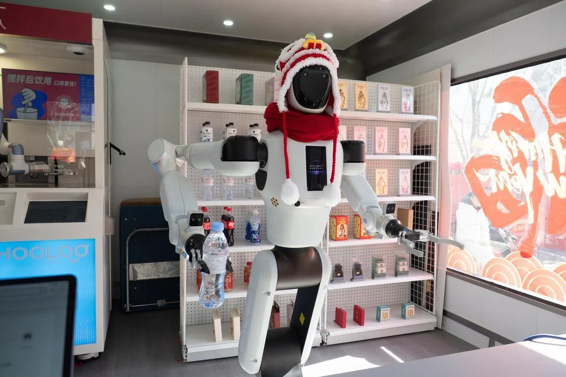 A Galbot self-service robot at Wangfujing in Beijing fetches a fridge magnet for a customer.