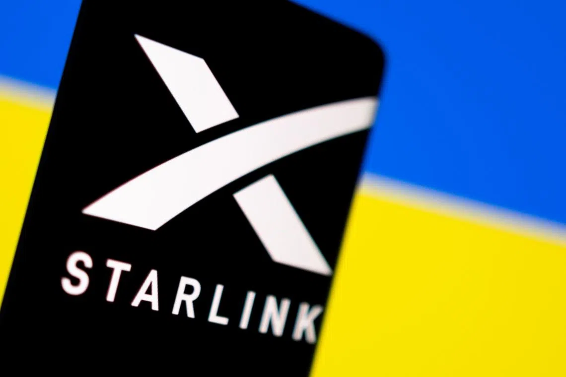 FILE PHOTO: Starlink logo is seen on a smartphone in front of displayed Ukrainian flag in this illustration taken February 27, 2022. REUTERS/Dado Ruvic/Illustration