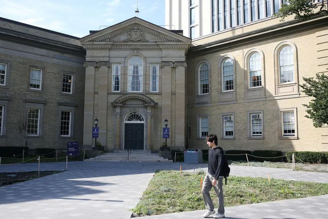 FILE PHOTO: A student walks in front of the University of Toronto, St. George campus, in Toronto, Ontario, Canada September 26, 2023.  REUTERS/Wa Lone