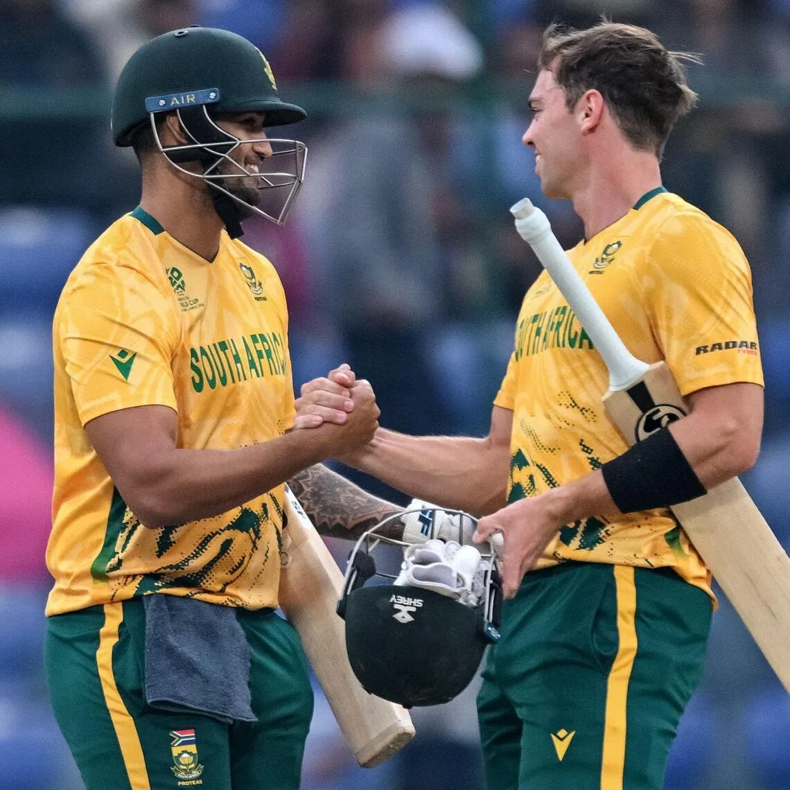 South Africa's Jason Smith (left) and Tristan Stubbs celebrate their win over United Arab Emirates in the ICC Men's T20 Cricket World Cup group-stage match at the Arun Jaitley Stadium in New Delhi on Feb 18, 2026.