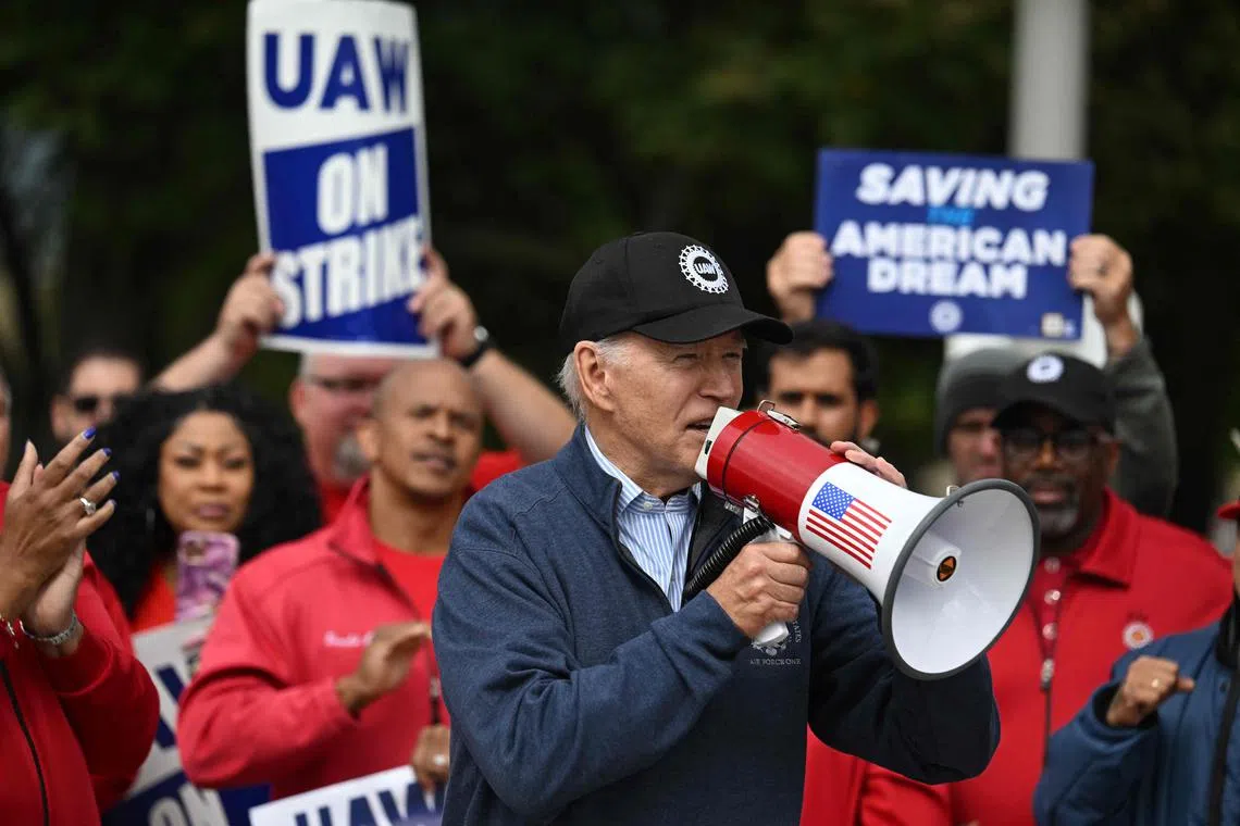 Wearing a baseball cap with the logo of the United Auto Workers union, US President Joe Biden told banner-waving workers that he was on their side.