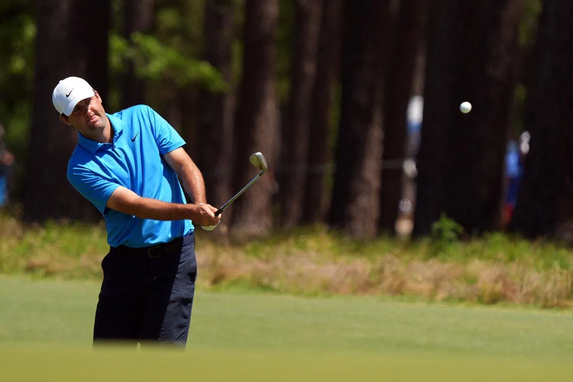 Jun 11, 2024; Pinehurst, North Carolina, USA; Scottie Scheffler chips up onto the 10th green during a practice round for the U.S. Open golf tournament at Pinehurst No. 2. Mandatory Credit: Katie Goodale-USA TODAY Sports