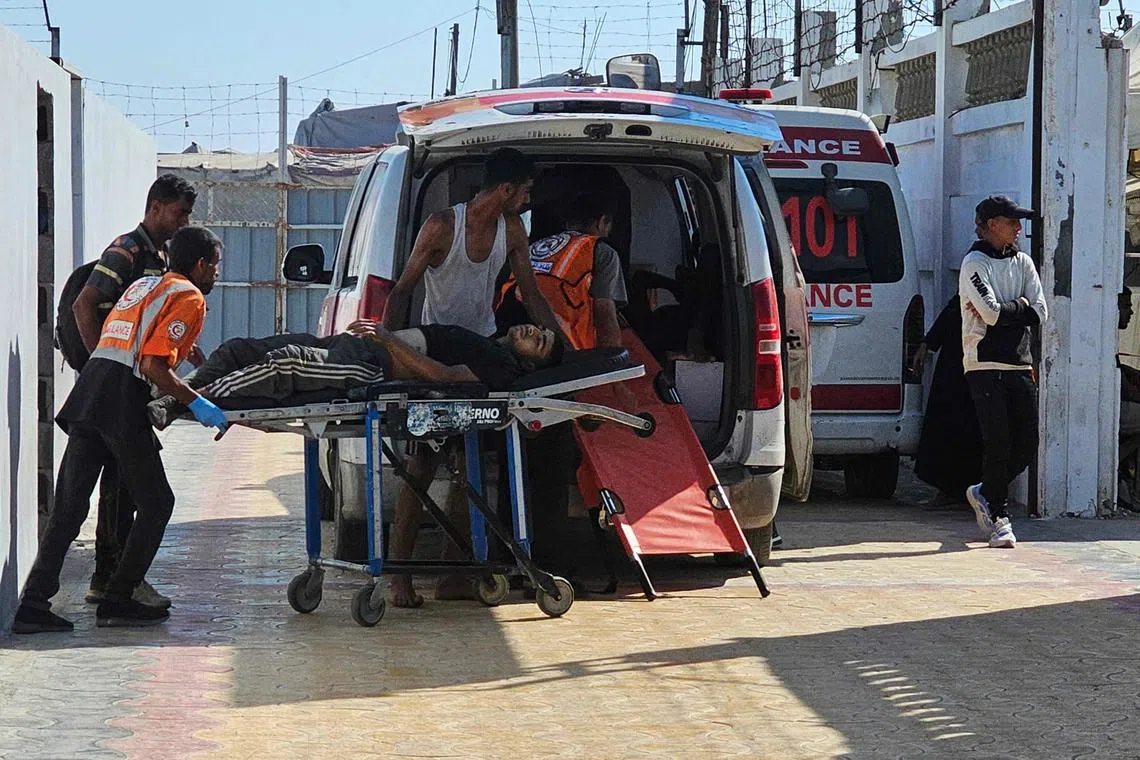 Injured victims of Israeli fire being taken to the Red Cross field hospital in the southern Gaza Strip on July 20.