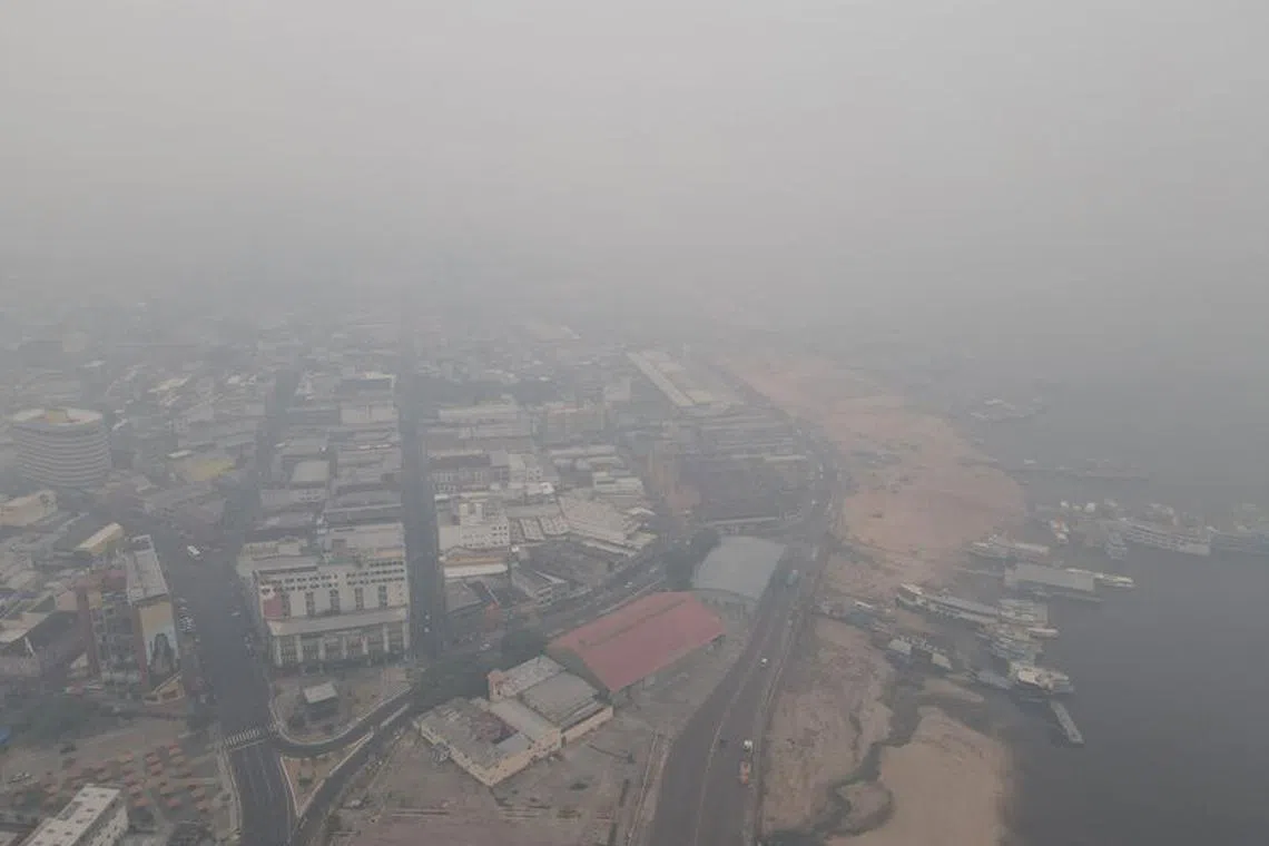 FILE PHOTO: Smoke from wildfires in the Amazon is seen in the port of Manaus, Brazil October 12, 2023. REUTERS/Bruno Kelly/File Photo