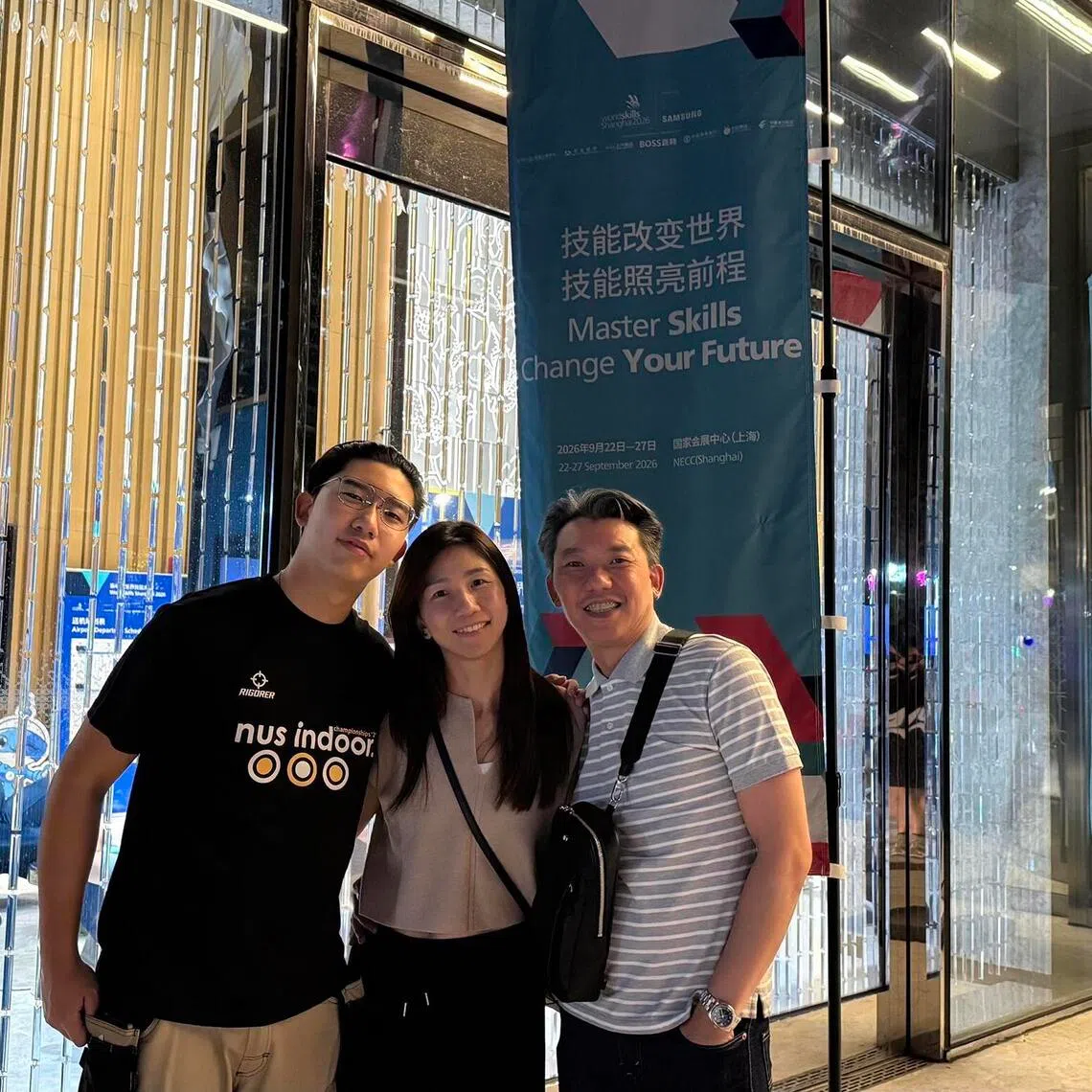 Aircraft maintenance competitor Aidan Wong with his parents Ellayne Soh and Joe Wong after the second day of the WorldSkills competition in Shanghai.