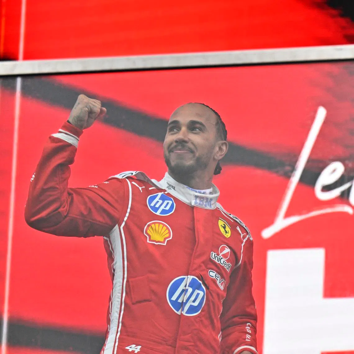 Second-placed Lewis Hamilton of Ferrari celebrates on the podium after the Canadian Grand Prix.