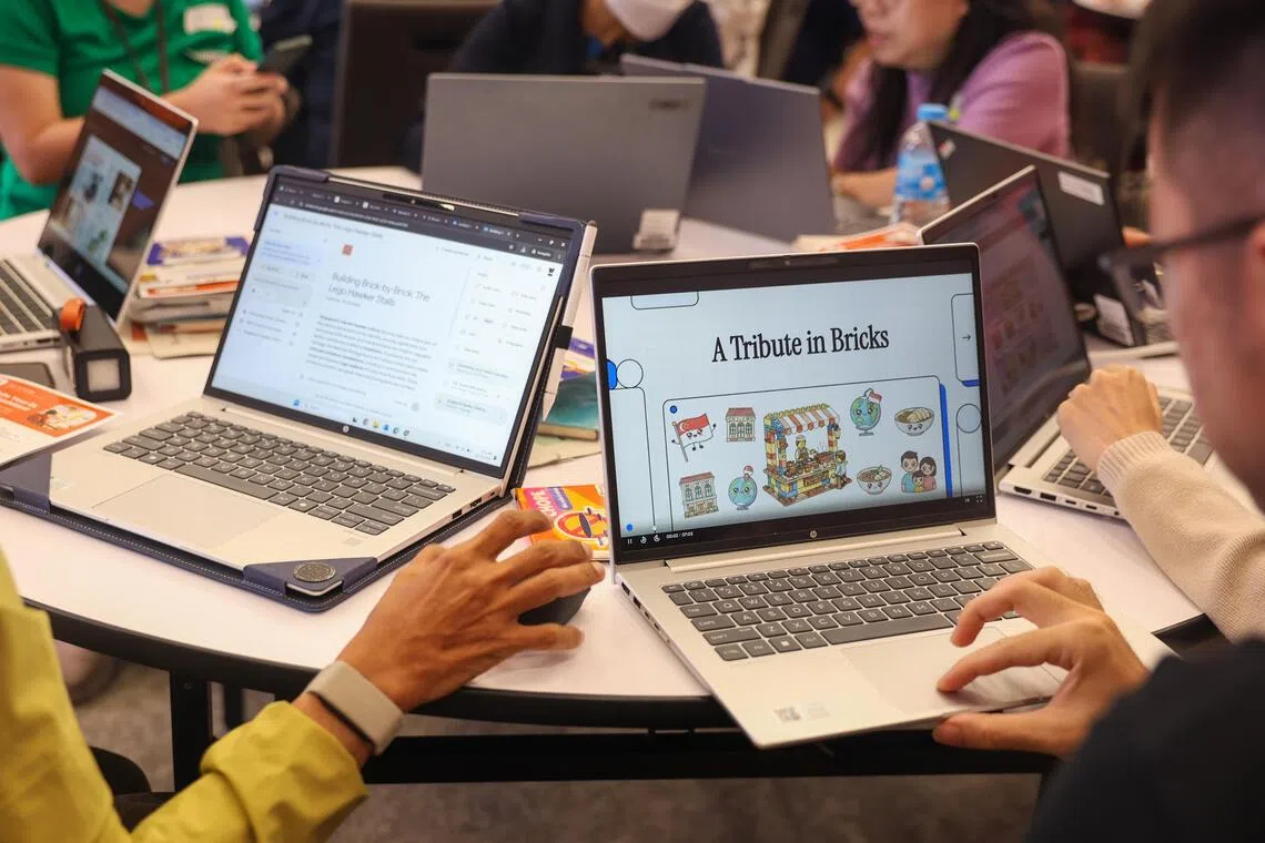 Primary and secondary school teachers looking through their creations in an interactive AI workshop organised by ST on Oct 29.