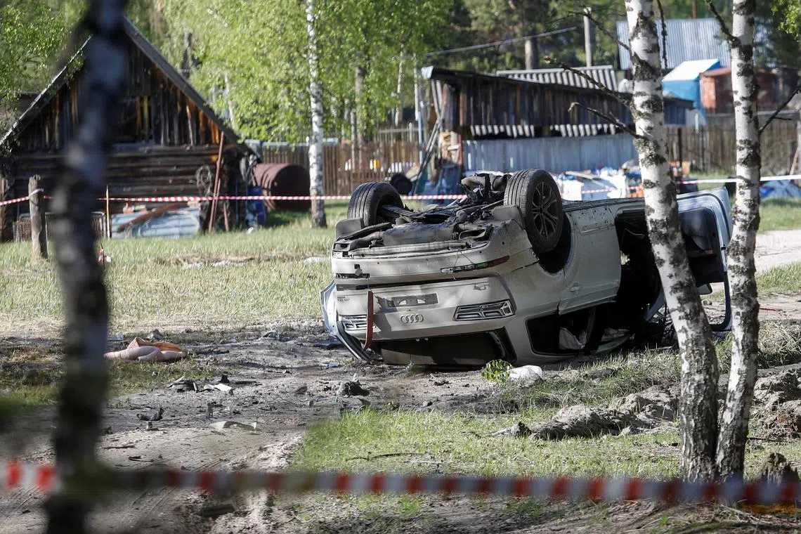 FILE PHOTO: A view shows a damaged white Audi Q7 car lying overturned on a track next to a wood, after Russian nationalist writer Zakhar Prilepin was allegedly wounded in a bomb attack in a village in the Nizhny Novgorod region, Russia, May 6, 2023. REUTERS/Anastasia Makarycheva/File Photo