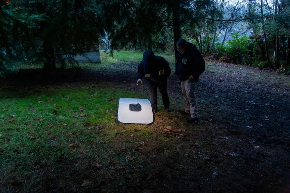 National Transportation Safety Board (NTSB) investigators examine the fuselage plug area of Alaska Airlines Flight 1282 Boeing 737-9 MAX, which was jettisoned and forced the aircraft to make an emergency landing, at a property where it was recovered in Portland, Oregon, U.S. January 8, 2024.  NTSB/Handout via REUTERS.